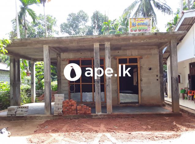 Land with house under construction for sale 